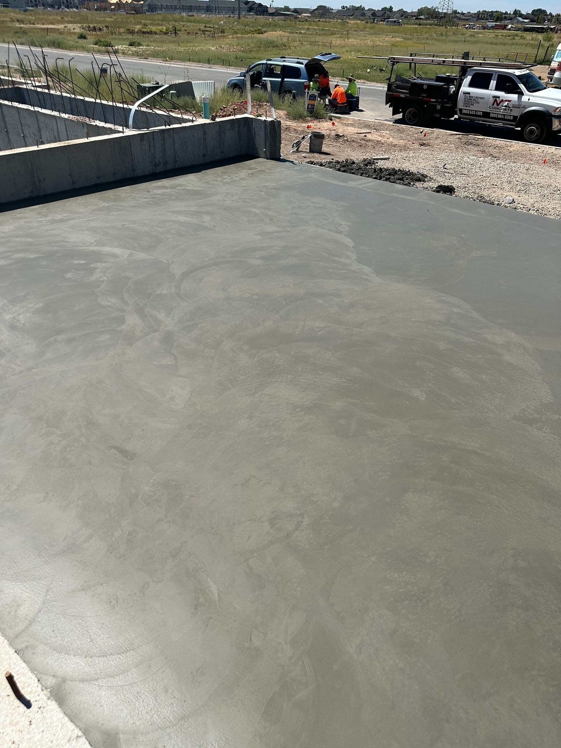 Freshly poured concrete surface; construction site, light gray.